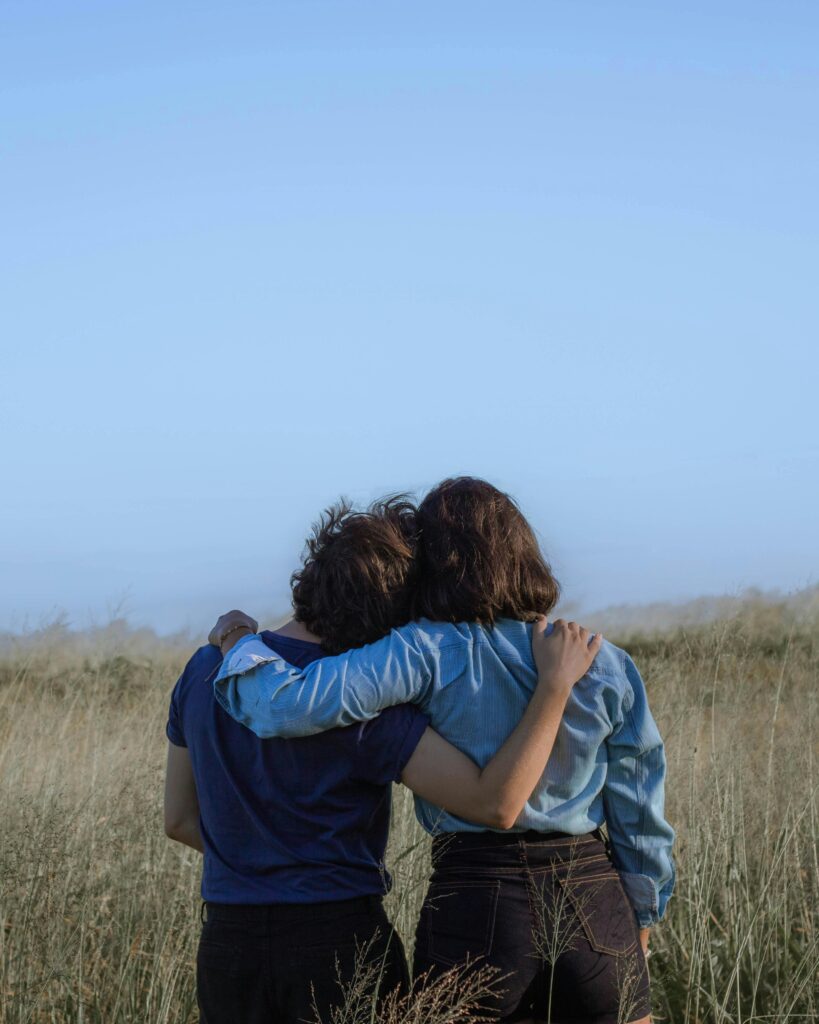 Two people hugging each other.